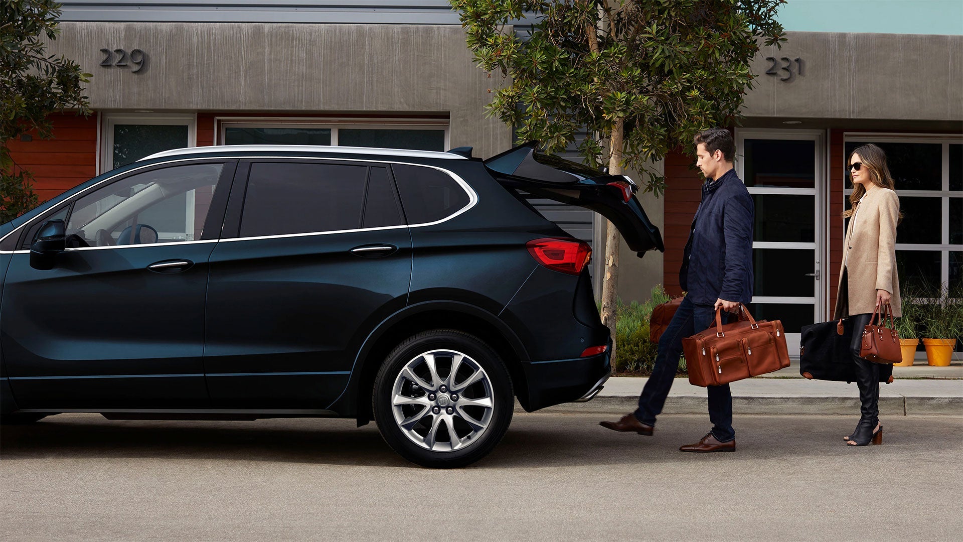 A man showing GMC Feature open trunk