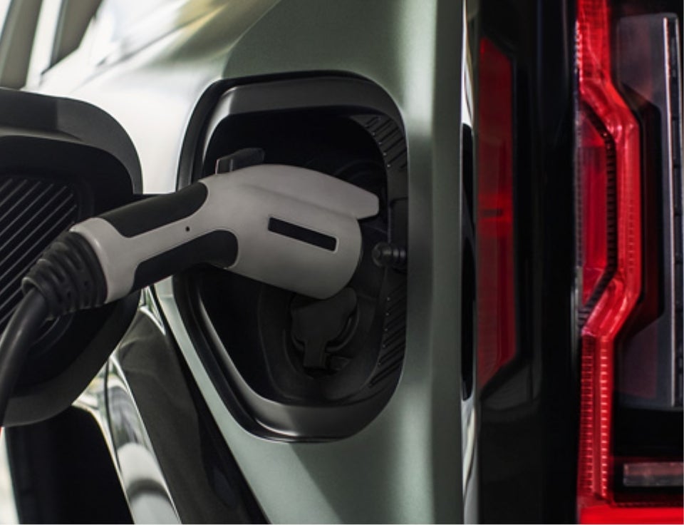 Close up of charging port with charger plugged in on a GMC Hummer EV SUV - Penske Buick GMC of Cerritos in CERRITOS CA